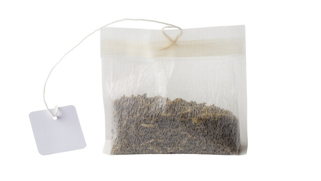 Square paper tea bag filled with dry tea leaves with white string and tag, isolated on transparent background