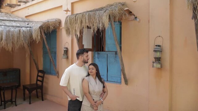 Romantic Couple Standing Outside Traditional Rustic House &ndash; Travel and Lifestyle Concept