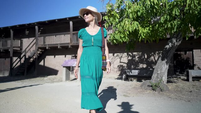 Happy senior woman enjoys a morning walk at Casa Grande in Sonoma, learning about the home of General Vallejo and its past.