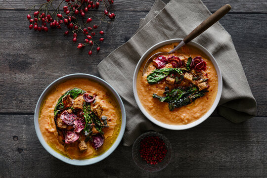 Studio shot of bowl of ready-to-eat pumpkin soup with croutons and beetroot chips