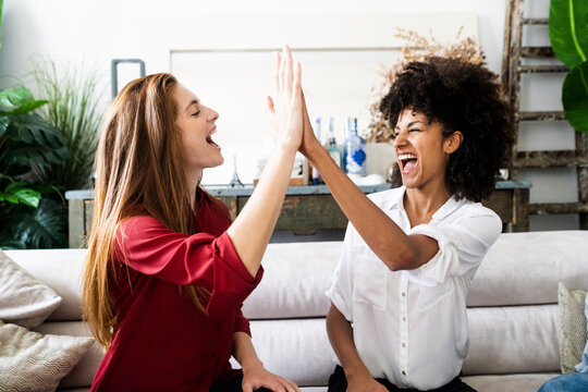 Girlfriends celebrating their success, highfiving