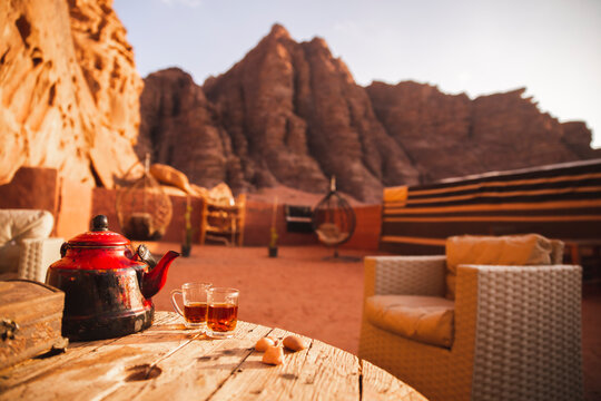 Tea on table at desert camp in front of mountains