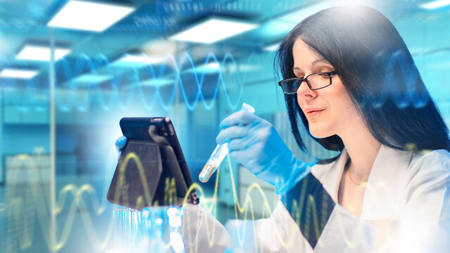 Laboratory research. Scientist analyzes chemical samples with a test tube and digital tablet, supporting biotechnology, pharmaceutical development and laboratory data analysis.