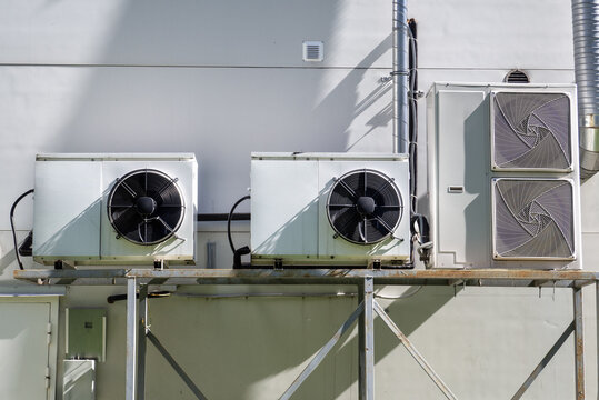 HVAC system. Industrial air conditioning and refrigeration units installed on a commercial building provide climate control, cooling and energy-efficient ventilation.