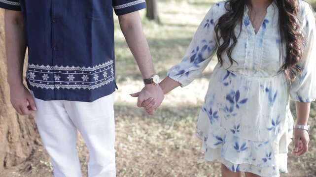 Romantic Couple Walking Together in a Serene Pine Forest During Daylight