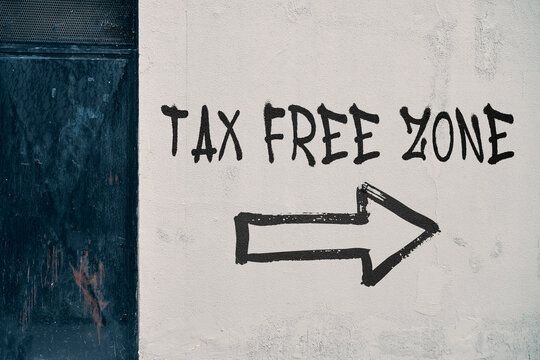 Tax free zone sign with pointing arrow on wall