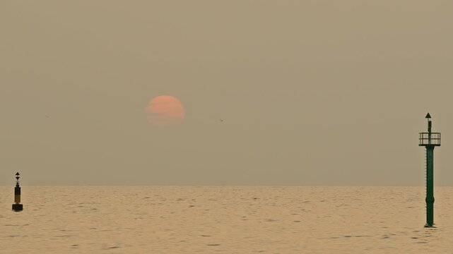 sun rising over the horizon on a hazy morning in barcelona