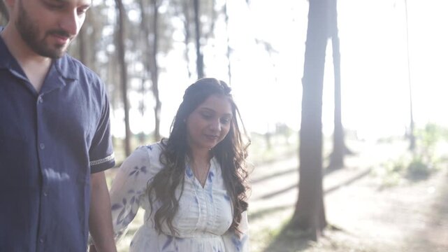 Romantic Couple Walking Together in a Serene Pine Forest During Daylight