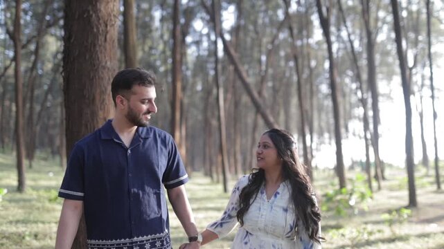 Romantic Couple Walking Together in a Serene Pine Forest During Daylight