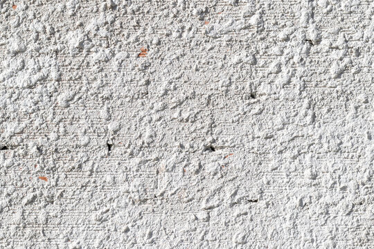 background texture of a white rough wall with coarse mortar plaster surface