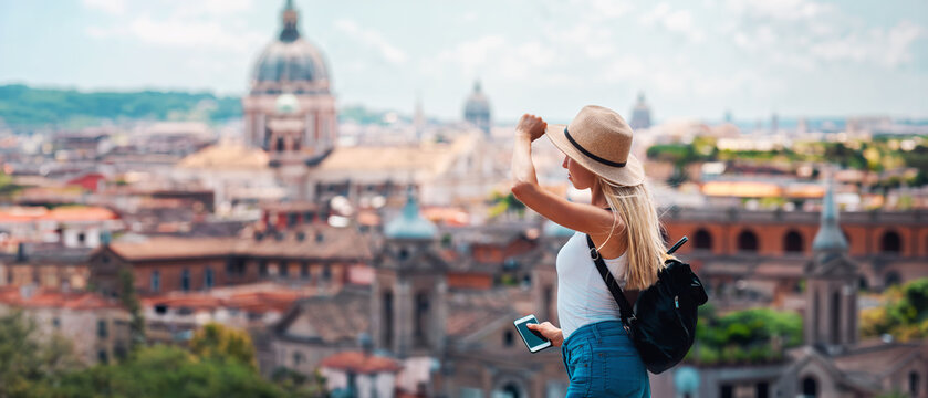 Young Female Tourist with Backpack and Smartphone Enjoying Panoramic View of Rome