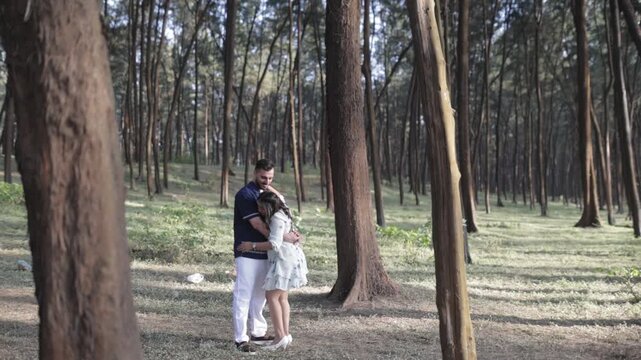 Romantic Couple Walking Together in a Serene Pine Forest During Daylight