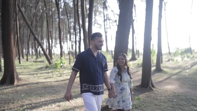 Romantic Couple Walking Together in a Serene Pine Forest During Daylight
