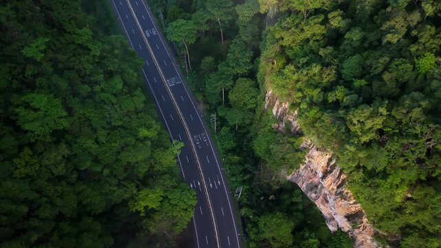 Aerial view of a scenic road through limestone karst mountains and morning mist in Krabi, Thailand