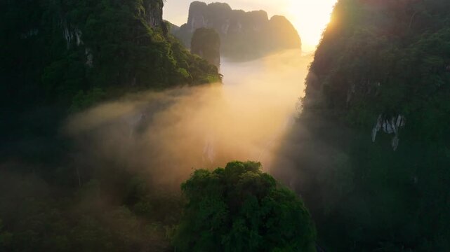 Aerial view of a scenic road through limestone karst mountains and morning mist in Krabi, Thailand
