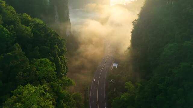 Aerial view of a scenic road through limestone karst mountains and morning mist in Krabi, Thailand