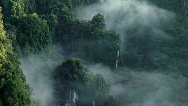 Aerial view of a scenic road through limestone karst mountains and morning mist in Krabi, Thailand