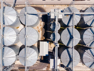 Grain silos and storage facilities seen from above on a sunny day in an agricultural area © DSMT