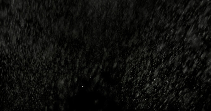 Realistic rain streaks isolated on a black background creating a realistic weather overlay with dynamic falling droplets perfect for visual effects compositing graphic design.