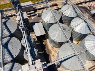 Grain storage facility showing multiple silos and infrastructure in an agricultural area © DSMT