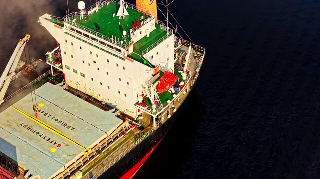 Riga, Latvia - 26 August 2025: Aerial view of a cargo ship on dark water.