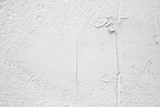 White textured plaster surface with uneven application