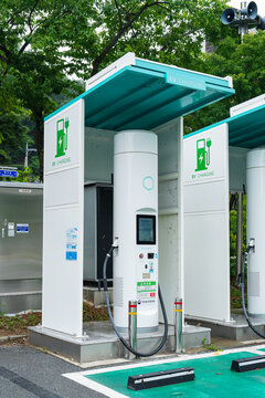 July 17, 2026, Andong, South Korea - Electric vehicle charging station with two white charging units and green canopy