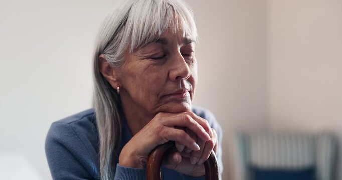 Senior, woman and thinking with cane in retirement home for nostalgia, past moment or reminisce. Thoughtful, elderly or female person contemplating with walking stick for old memory or daydreaming