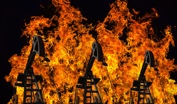 Oil pump jacks with large fire and smoke in background 