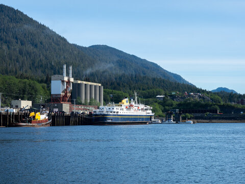 Ketchikan, Alaska, USA - June 1, 2022: MV Malaspina,retired ferry vessel, moored at Ketchikan's Ward Cove with silos and forested mountains in the background