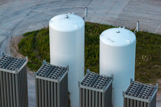 Aerial view of liquid gas storage tanks and industrial heat exchangers in a facility in Poland.