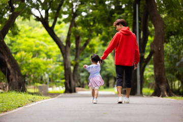 Obraz premium Energy, Asian girl and father running outdoor for child development or growth. Adventure, excited and path with happy kid in nature park for outdoors activity. Healthy outdoor sport for kids.