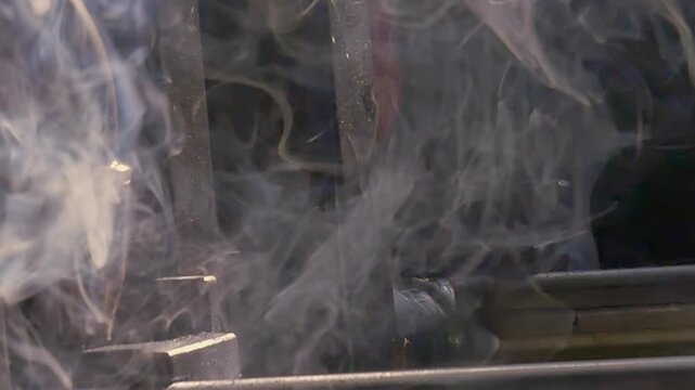 Experience impressive precision of industrial argon welding robot as it meticulously crafts metal. Witness sparks flying and smoke swirling in enchanting slow motion display of technology and artistry