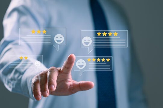 Businessman points finger selecting virtual customer feedback star rating icons representing positive user experience satisfaction survey evaluation business performance quality index.