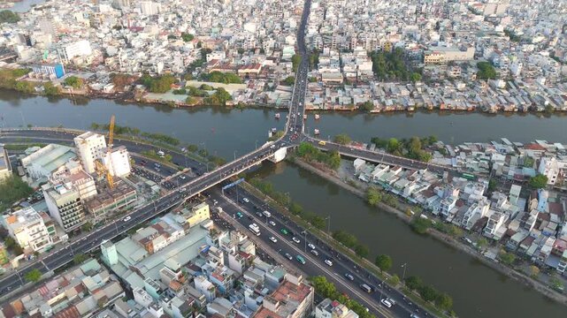 rone shot of the famous Y-shaped Chu Y Bridge over Ben Nghe Canal with vehicle traffic during daylight in Ho Chi Minh City, Vietnam.