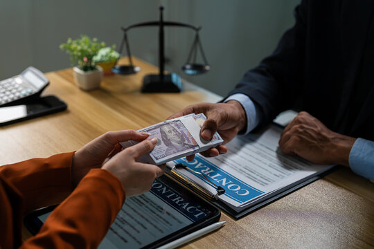 Businessman secretly giving money bribe to law officer or partner under a contract agreement.