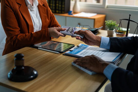 Businessman secretly giving money bribe to law officer or partner under a contract agreement.