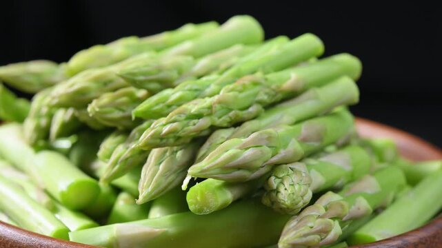Fresh Green Asparagus Spears on Wooden Plate