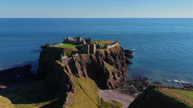 Beautiful cinematic Aerial footage of Dunnottar Castle and Dramatic Cliffs, Stonehaven Scotland &ndash; Historic Medieval Fortress on the North Sea	