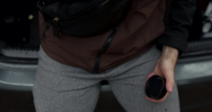 Close up of man hands opening and closing thermos to drink tea with audio included