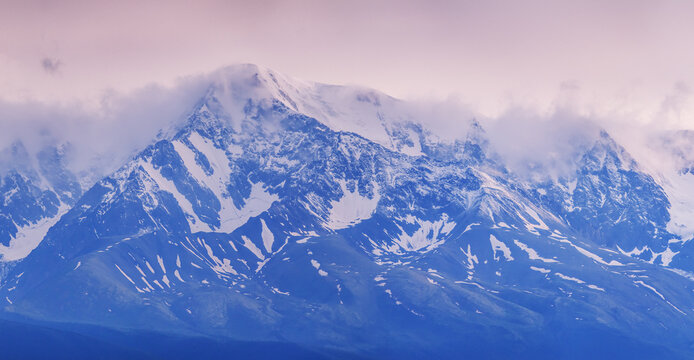 Mountain landscape in the sunset light, snow-capped peaks, glaciers, mountain climbing and mountaineering