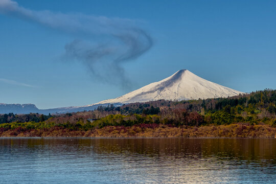 Villarrica volcano steaming over tranquil lake pucon