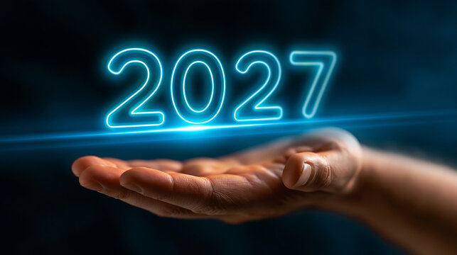 Hand holding holographic glowing 2027 sign with hologram technology innovation