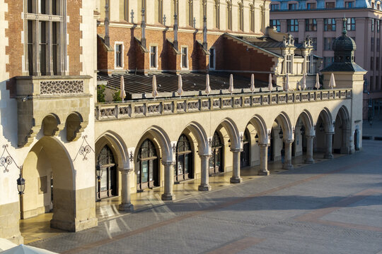 Aerial view of the historic Sukiennice Cloth Hall in the Main Market Square, featuring its iconic Renaissance arcades, stone columns, and ornate roofline in Krakow, Malopolskie, Poland.