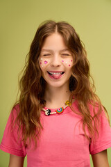 Little girl shows her playful side with vibrant smiles and stylish accessories