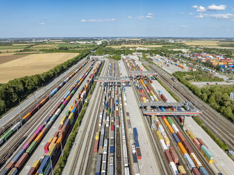 Munich, Germany - 20 July 2026: Aerial view of Container Terminal Munchen with rows of colorful shipping containers, freight trains, and gantry cranes in a busy logistics hub.