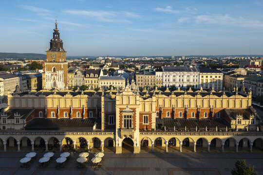 Krakow, Poland - 25 July 2026: Aerial view of the historic Cloth Hall in the main market square with its Renaissance architecture, arched arcades, and surrounding city rooftops under a clear blue sky.