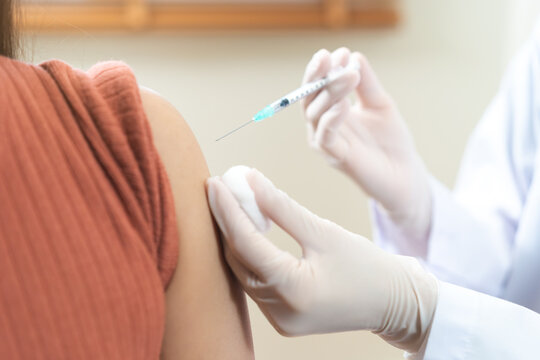 Health care, corona virus, hand of woman nurse, doctor giving syringe vaccine, injection dose on arm sick patient at clinic. Vaccination, immunization disease prevention against flu pandemic influenza