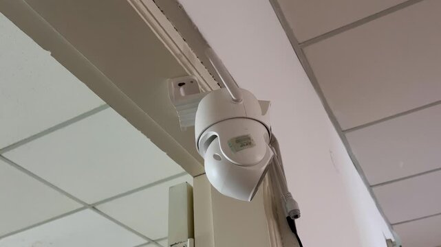 Robotic security camera remotely monitoring and scanning an indoor area. ensuring home safety with its advanced motion detection system.Home security devices concept.