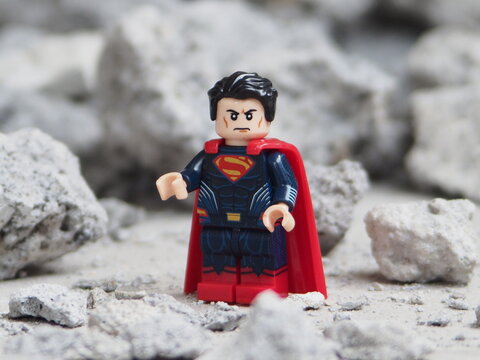 Indonesia - May 8, 2025 : Mini toy of action figure at table with blurred background. Toy photography concept design. Minifigure of Superman character from DC comics film.